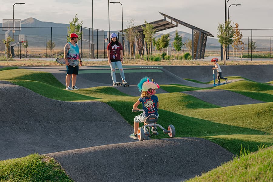 Young children riding bikes on the Firefly pump track